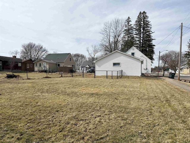 view of yard with a residential view and fence