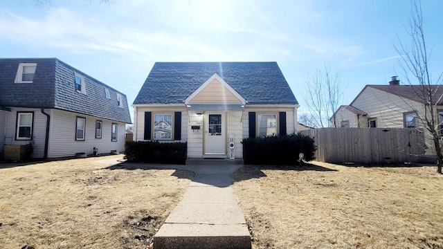 bungalow featuring fence and a shingled roof