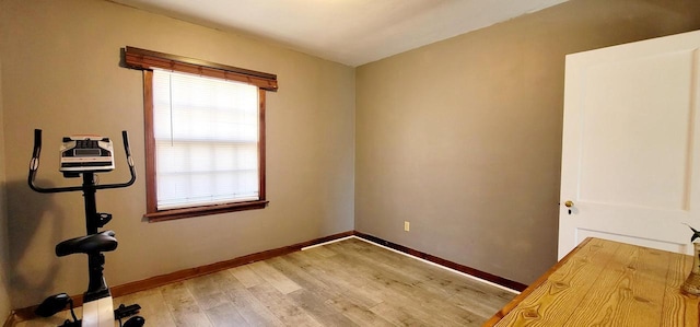 spare room with light wood-type flooring and baseboards