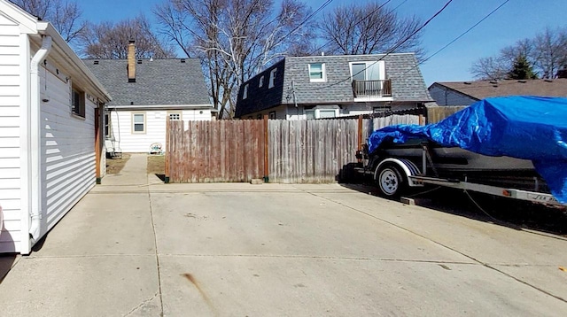 exterior space featuring a patio area, a chimney, and fence