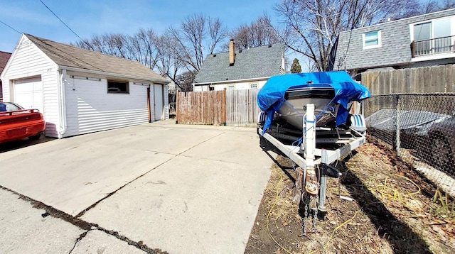 view of yard featuring an outbuilding, fence, and a garage