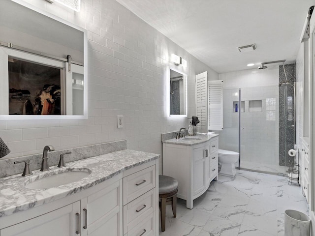 bathroom with visible vents, marble finish floor, a shower stall, and a sink