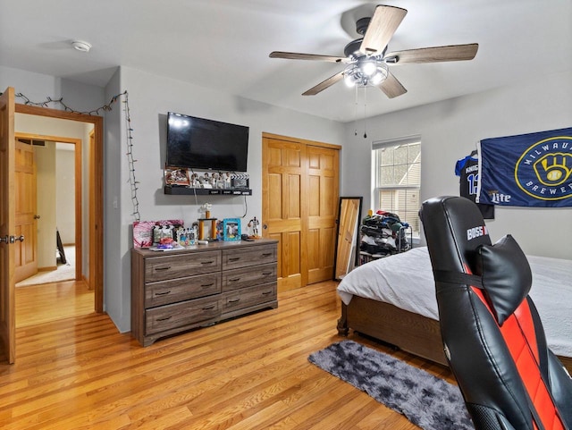 bedroom with light wood finished floors and a ceiling fan