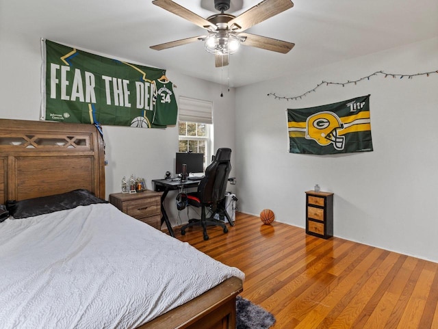 bedroom with wood finished floors and a ceiling fan