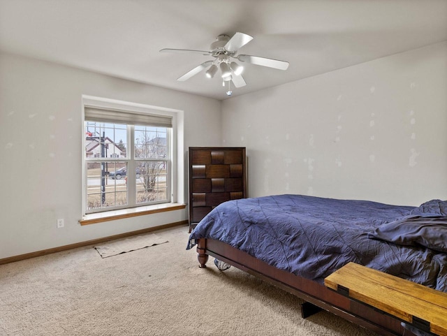 carpeted bedroom with baseboards and a ceiling fan