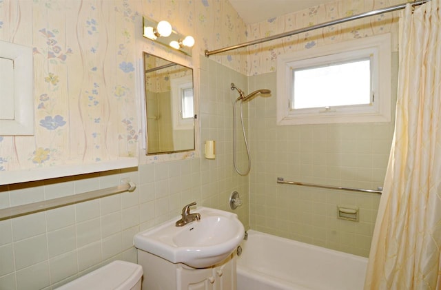 5511 Maywood Rd, Monona, WI 53716 - full bathroom with vanity, shower / bathtub combination with curtain, wallpapered walls, tile walls, and toilet