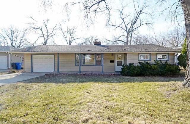 5511 Maywood Rd, Monona, WI 53716 - ranch-style house featuring concrete driveway, a garage, a front yard, and a chimney
