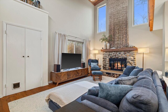 3103 W Riverland Dr, Mequon, WI 53092 - living area with a fireplace, a high ceiling, and wood finished floors