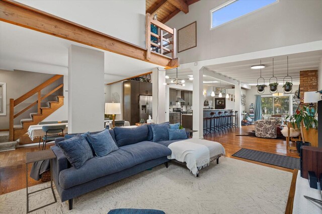 3103 W Riverland Dr, Mequon, WI 53092 - living area featuring beamed ceiling, wooden ceiling, wood finished floors, and stairway