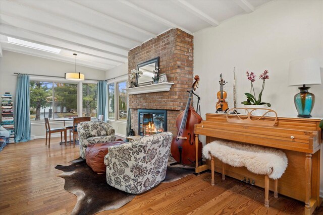 3103 W Riverland Dr, Mequon, WI 53092 - living room with a fireplace, baseboards, vaulted ceiling with beams, and wood finished floors