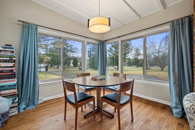 3103 W Riverland Dr, Mequon, WI 53092 - dining space featuring a wealth of natural light, lofted ceiling with beams, baseboards, and wood finished floors