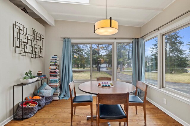 3103 W Riverland Dr, Mequon, WI 53092 - dining area featuring lofted ceiling with beams, baseboards, and wood finished floors