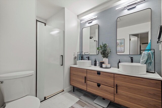3103 W Riverland Dr, Mequon, WI 53092 - bathroom featuring double vanity, a sink, toilet, and a shower stall