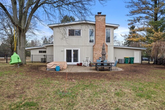 3103 W Riverland Dr, Mequon, WI 53092 - back of property featuring a lawn, a chimney, fence, and a patio area