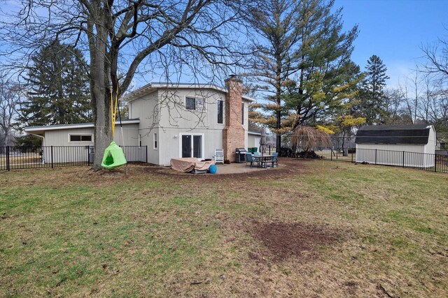 3103 W Riverland Dr, Mequon, WI 53092 - back of property featuring a lawn, a chimney, a patio, and fence private yard
