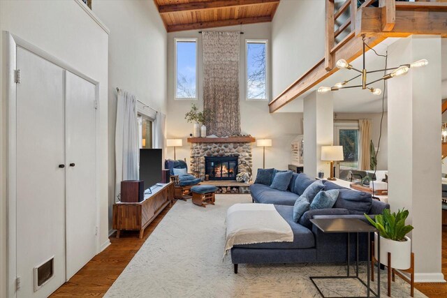 3103 W Riverland Dr, Mequon, WI 53092 - living room featuring wood ceiling, beamed ceiling, visible vents, a fireplace, and wood finished floors