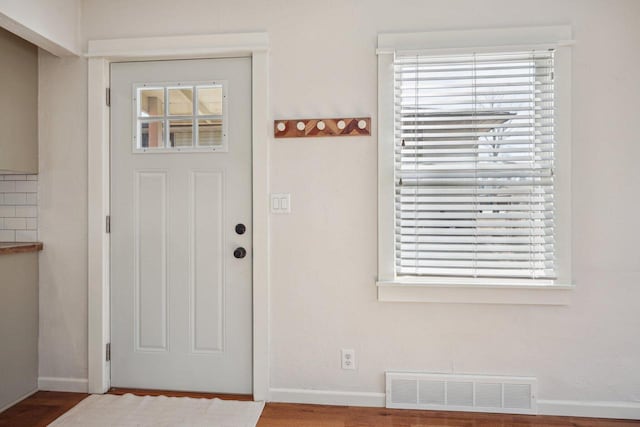 foyer featuring visible vents and baseboards