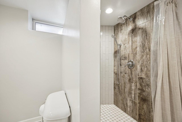 full bathroom with toilet and tiled shower