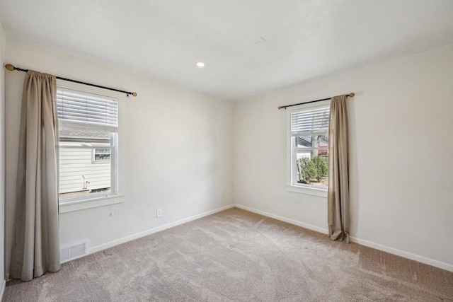 unfurnished room with visible vents, recessed lighting, baseboards, and carpet