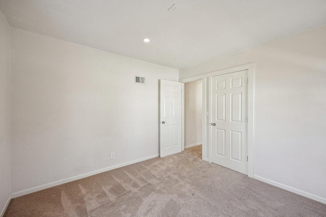 interior space with recessed lighting, carpet, visible vents, and baseboards