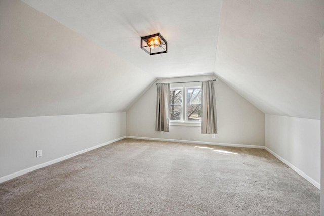 bonus room with baseboards, carpet, and vaulted ceiling