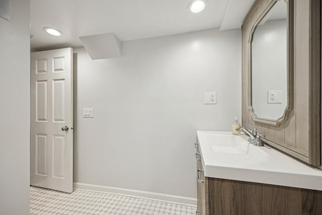 bathroom with recessed lighting, baseboards, and vanity