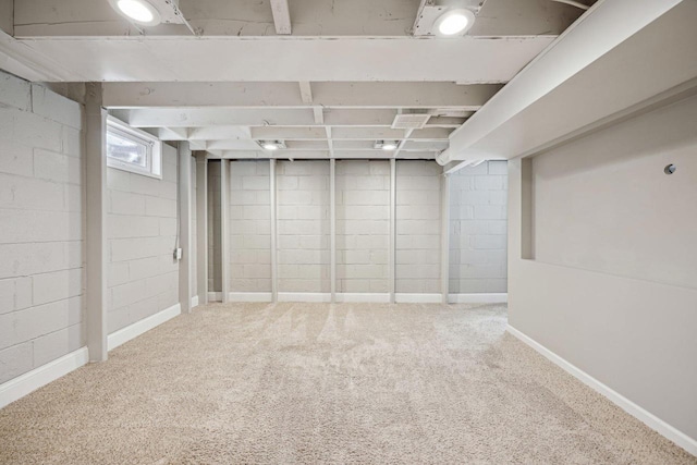 basement with baseboards and carpet