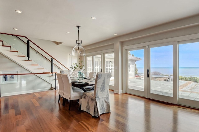 dining room featuring recessed lighting, stairs, baseboards, and wood finished floors