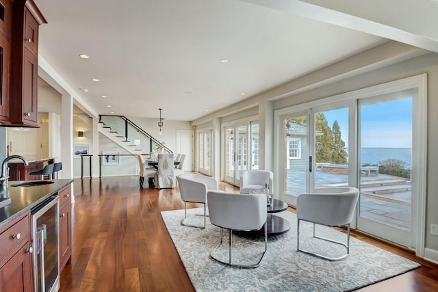 interior space with wine cooler, recessed lighting, dark wood finished floors, and stairs