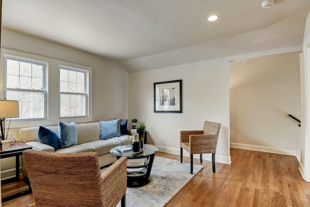 living room with recessed lighting, light wood-type flooring, baseboards, and vaulted ceiling