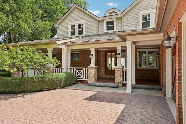 doorway to property featuring covered porch