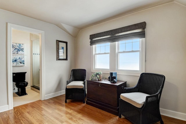 living area with light wood-type flooring and baseboards