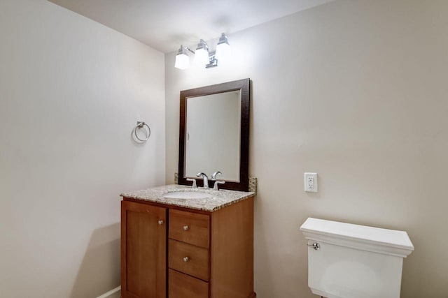 half bathroom with toilet and vanity