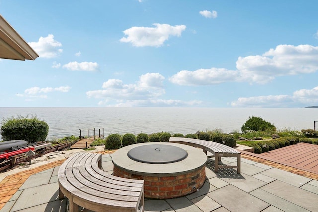 view of patio featuring a water view and an outdoor fire pit