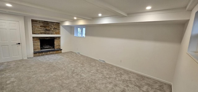 basement featuring visible vents, recessed lighting, carpet floors, a fireplace, and baseboards