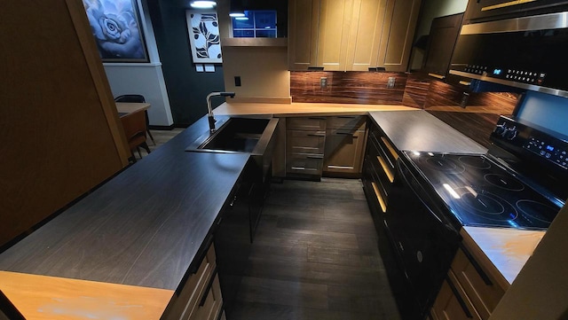 kitchen with a sink, backsplash, black range with electric stovetop, light countertops, and dark wood-style flooring