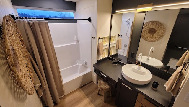 bathroom featuring vanity, wood finished floors, and shower / tub combo