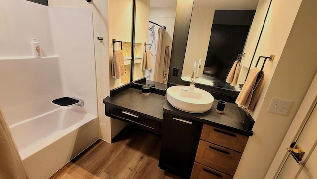 bathroom with vanity, shower / bath combo with shower curtain, and wood finished floors