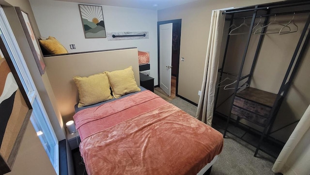 bedroom with carpet, a closet, and baseboards