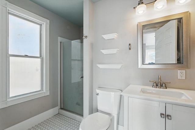 full bath featuring baseboards, vanity, toilet, and a shower stall