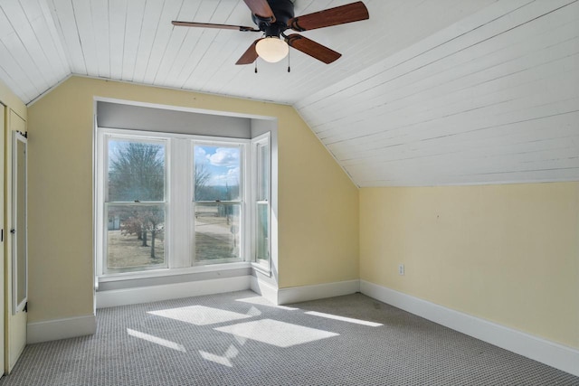 bonus room featuring baseboards, lofted ceiling, ceiling fan, and carpet flooring