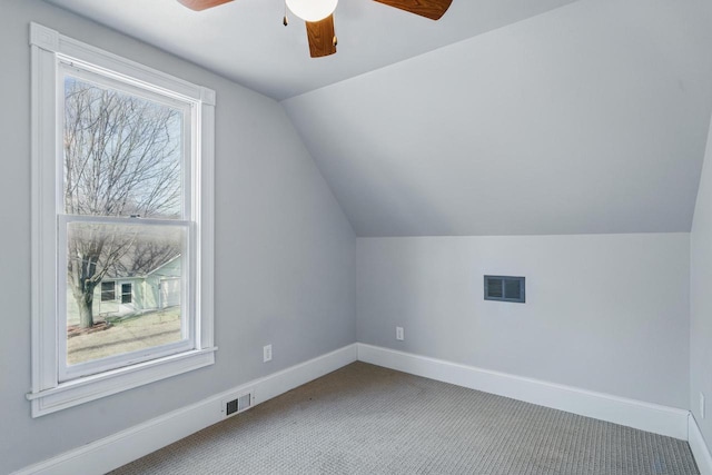 additional living space with visible vents, plenty of natural light, ceiling fan, and carpet floors