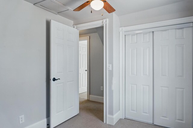 unfurnished bedroom with a ceiling fan, light colored carpet, baseboards, and a closet