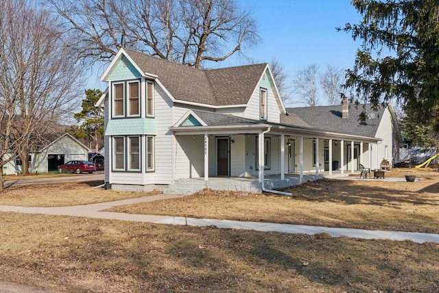 view of front of home with a porch, a front yard, and roof with shingles