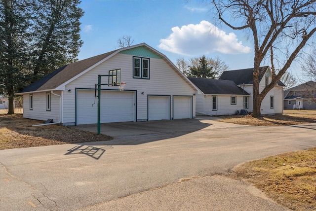 view of front facade with concrete driveway and a garage