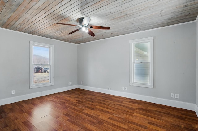 empty room with baseboards, wood finished floors, a ceiling fan, and crown molding