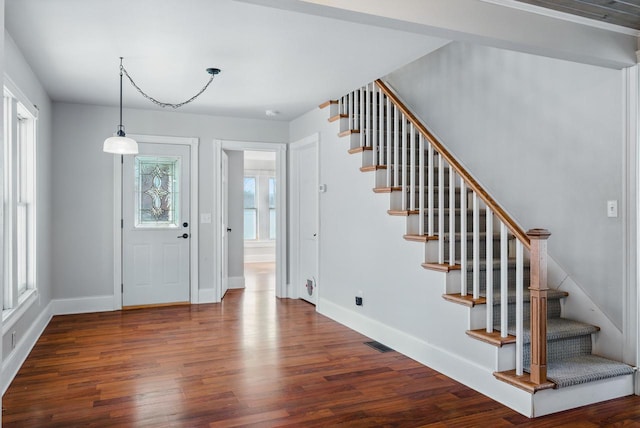 entrance foyer featuring stairs, wood finished floors, and baseboards