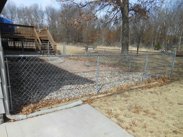 view of yard featuring stairs, a deck, and fence