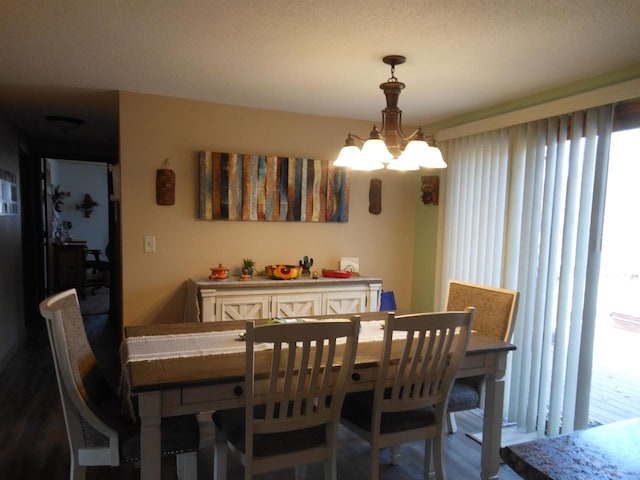 dining area with a wealth of natural light and a chandelier