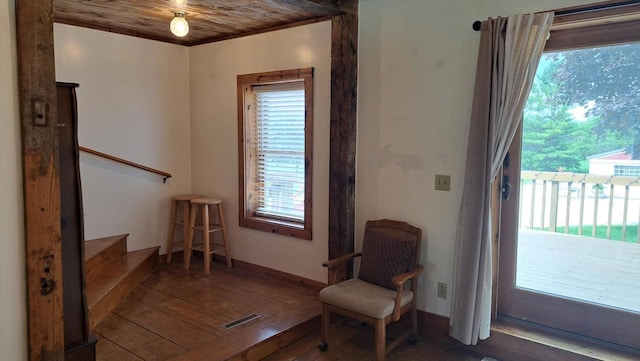 living area with visible vents, plenty of natural light, stairs, and hardwood / wood-style flooring